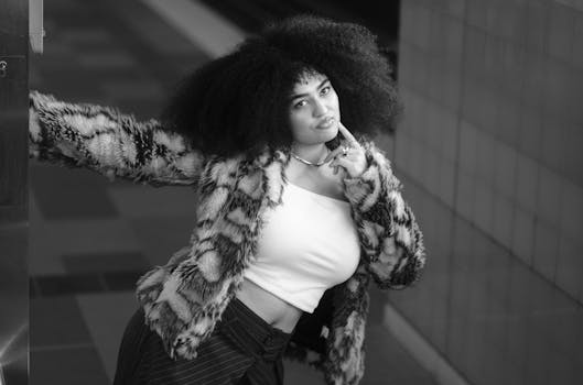 Portrait of a fashionable woman with curly hair in an urban setting.