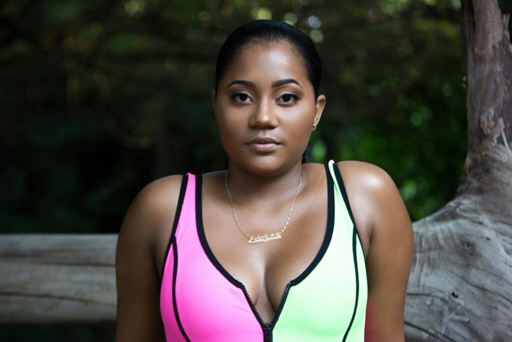 Captivating outdoor portrait of a confident woman in a vibrant athletic outfit, exuding natural beauty and grace.