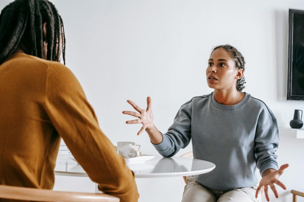 A couple engaged in a serious discussion at a home table.