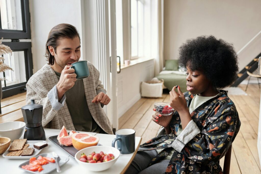 A couple enjoying a healthy breakfast together in a bright and cozy loft setting.