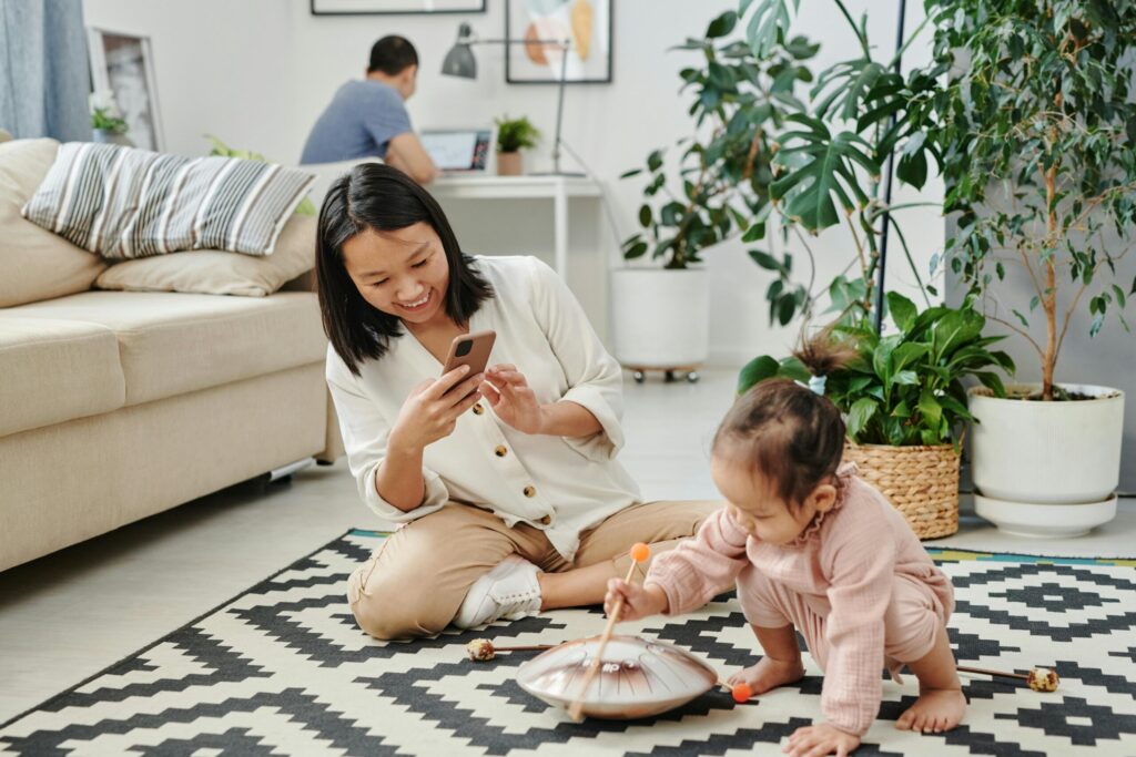 A mother captures a playful moment with her child in a stylish living room.
