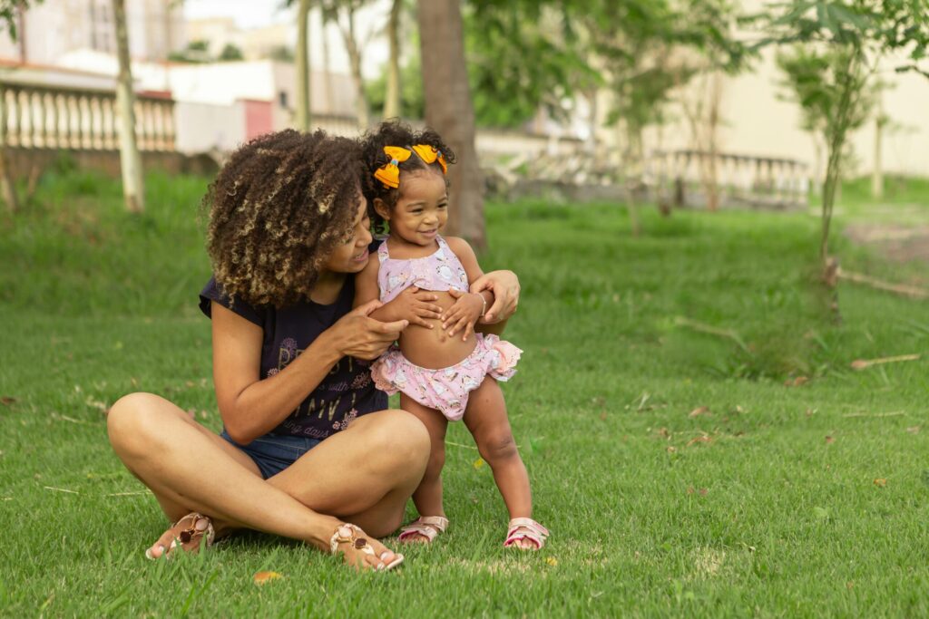 A loving mother and daughter enjoying quality time together in a lush green park.